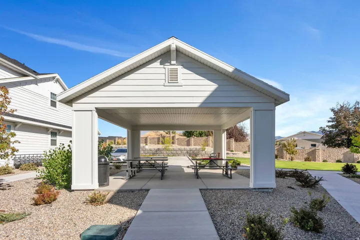 Outdoor covered patio structure with white siding and a sloped roof