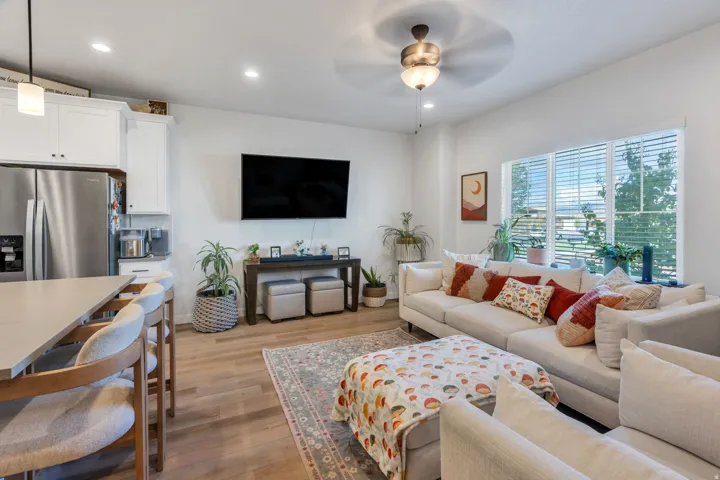 Open-concept living area featuring wood-finish flooring, recessed lighting, and a ceiling fan