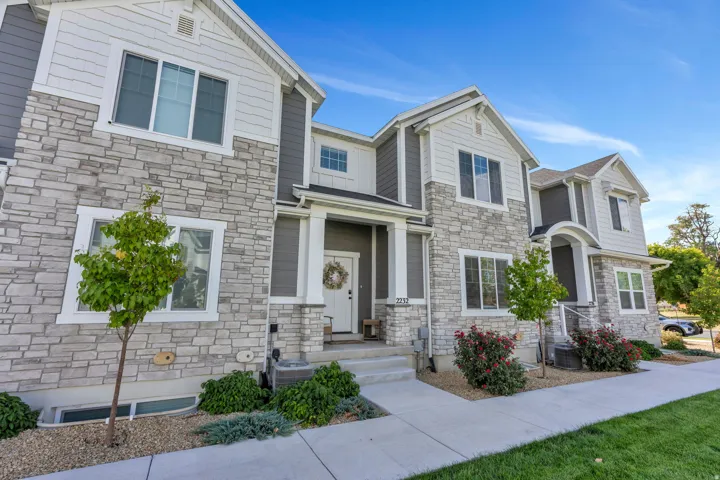 Multi-story exterior featuring stone veneer and horizontal siding