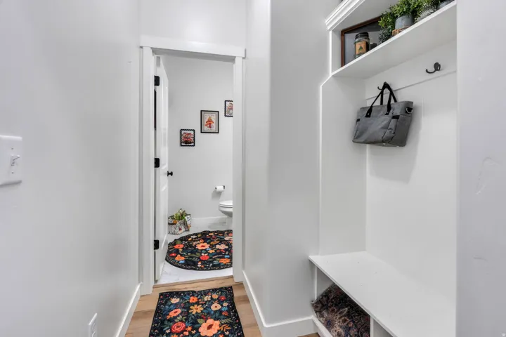Built-in entry bench with storage, upper shelf, and coat hooks