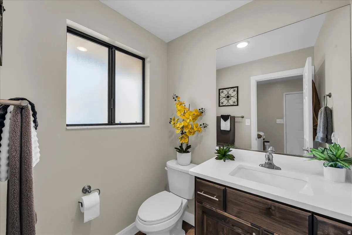 Built-in vanity with a single basin sink and a stone countertop