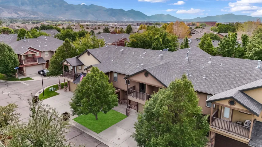 Townhome community with asphalt shingle roofing, integrated garages, and private balconies