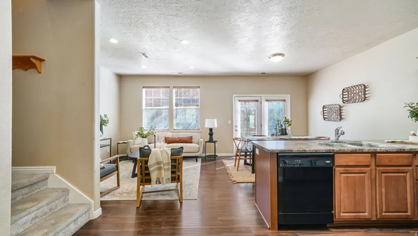 Wood-finish flooring, recessed lighting, and kitchen island with built-in dishwasher