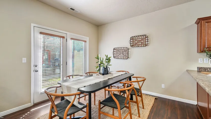 Wood-finish flooring throughout, light-toned wall paint, and a glass-paneled door with blinds