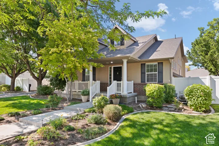 Traditional-style exterior with a covered porch, white railing, and dark shutters