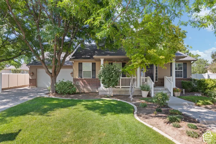 Ranch-style exterior with a covered porch and white railing