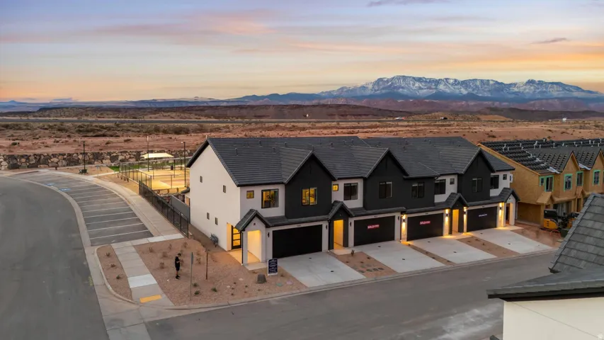 Contemporary townhomes featuring dark-toned siding and light-toned accents