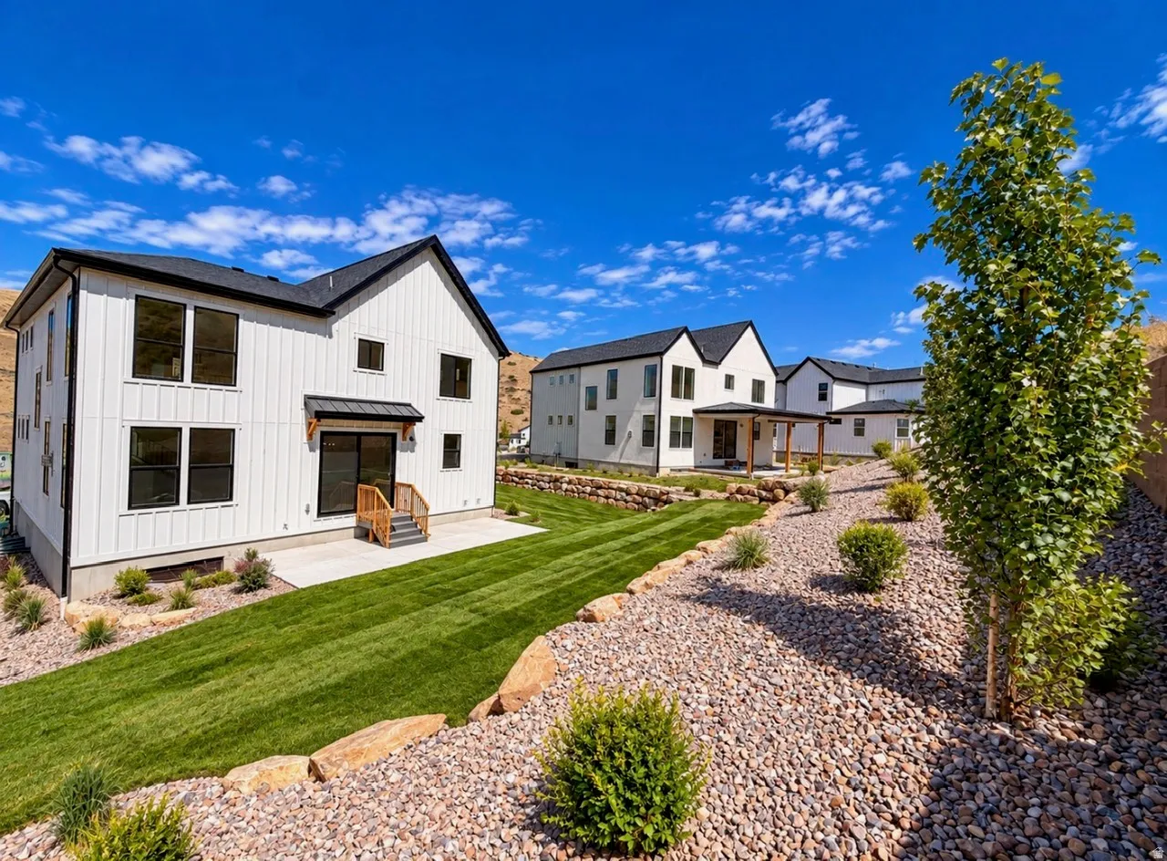 White vertical siding, black-framed windows, and a black roofline define this modern exterior