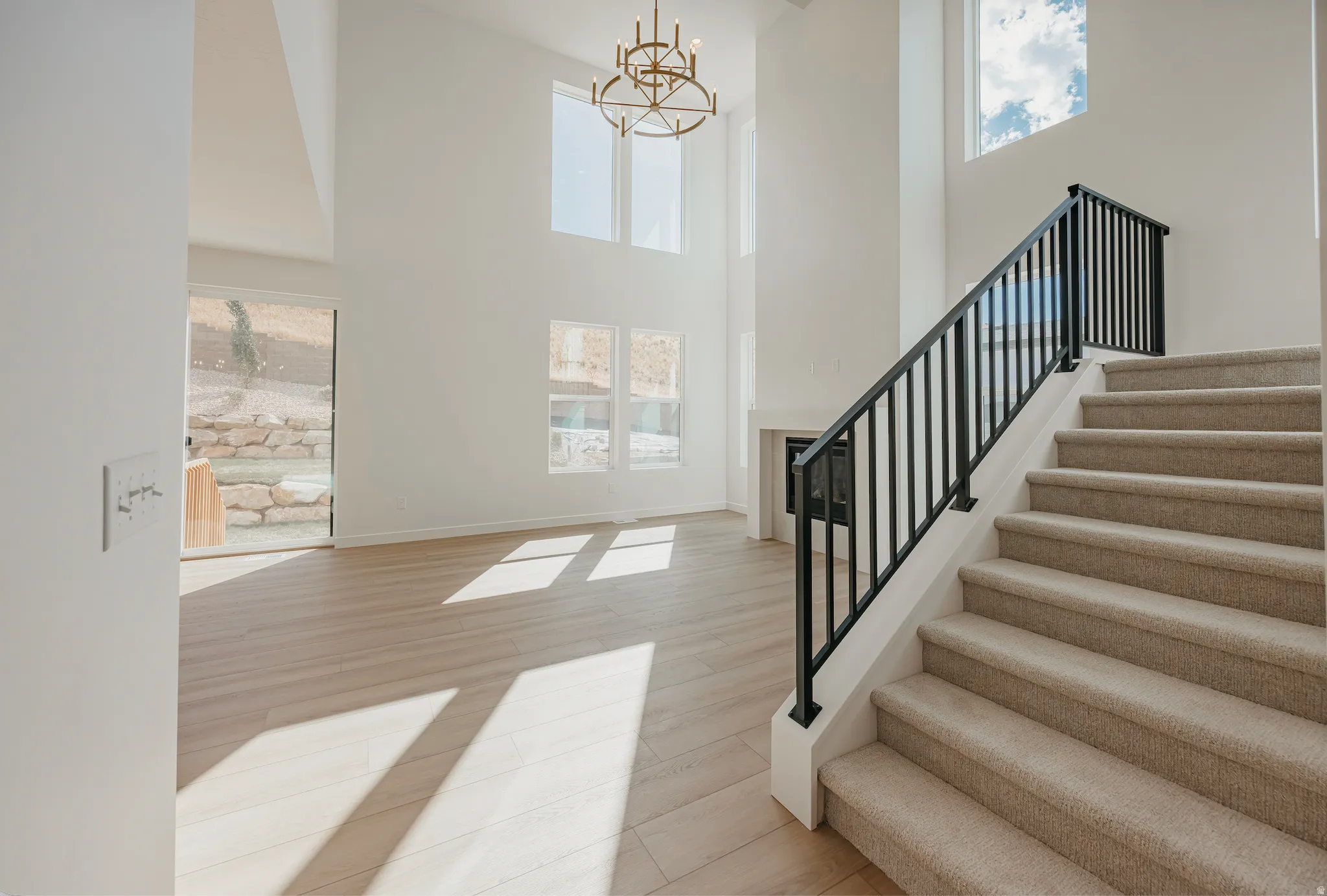 High ceilings complement a built-in fireplace and wood-finish flooring