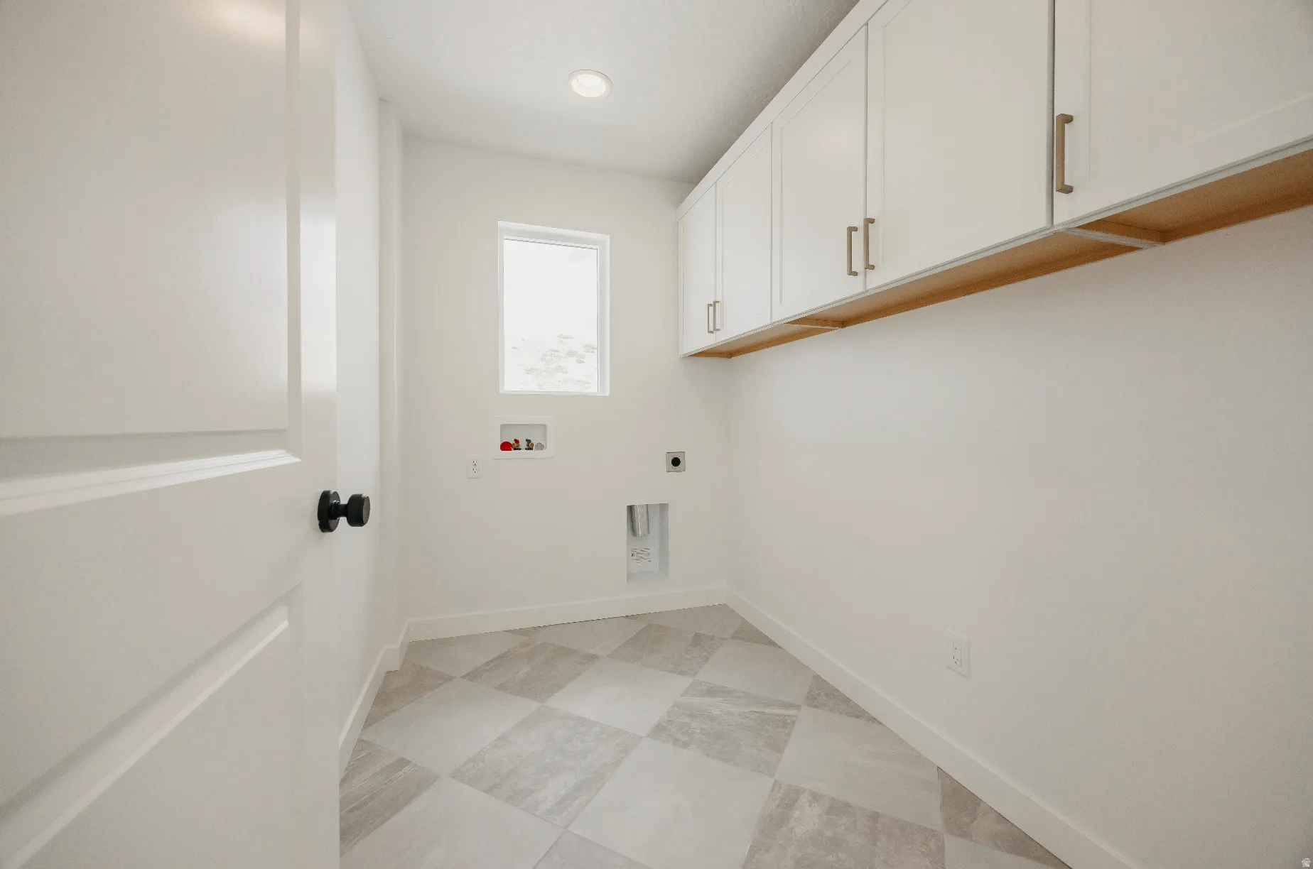 White shaker-style cabinetry with gold-finish hardware