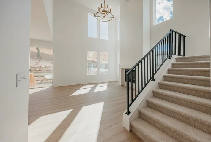 High ceilings complement a built-in fireplace and wood-finish flooring