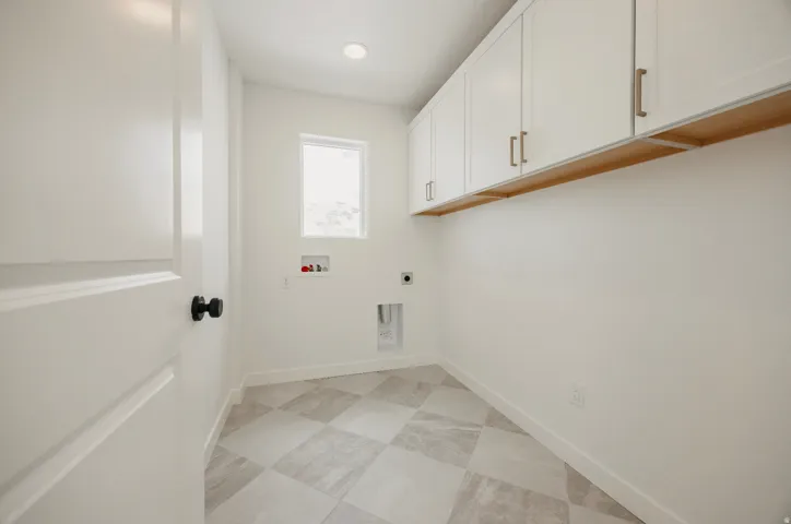 White shaker-style cabinetry with gold-finish hardware