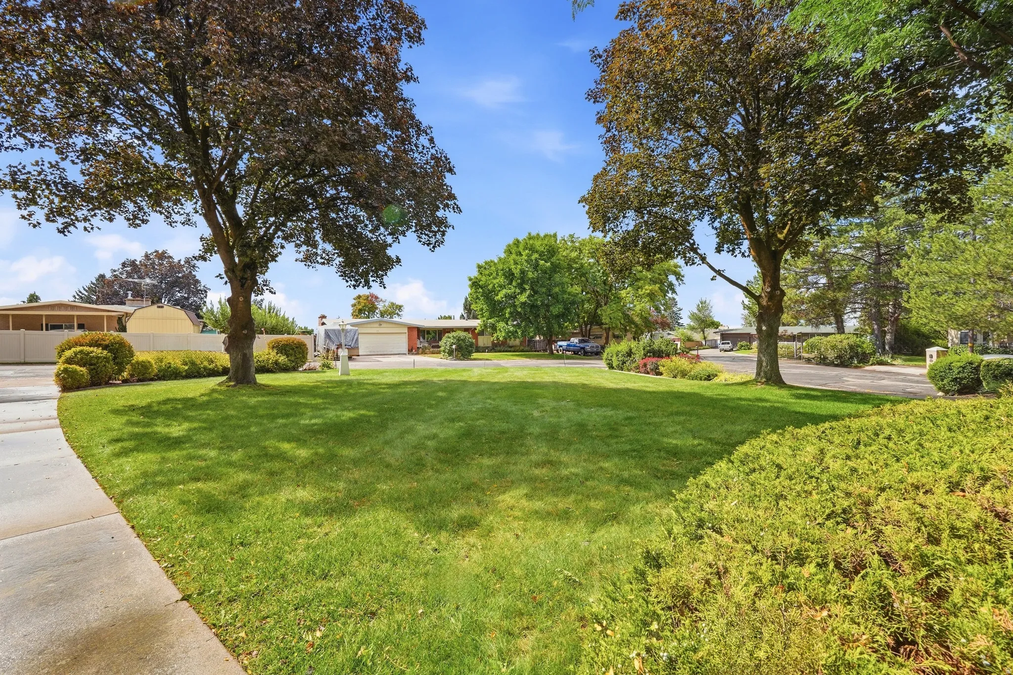 Manicured lawn with mature trees and established landscaping