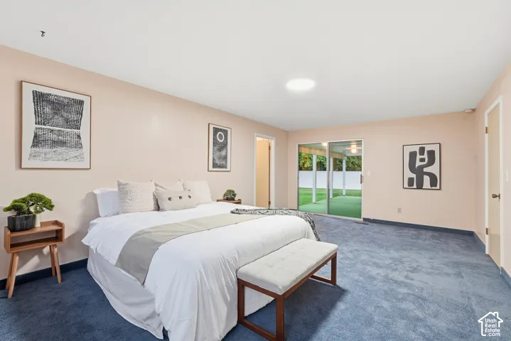 Sliding glass doors opening to the exterior, recessed ceiling light, and blue carpeting