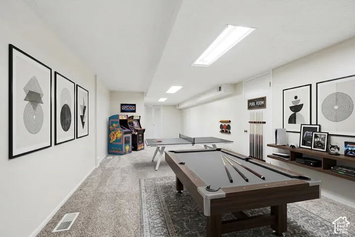 Finished lower level with recessed lighting and neutral carpeting