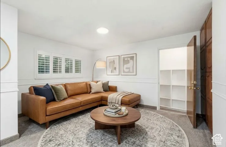 Recessed lighting, window shutters, built-in shelving, wood door, and white wainscoting