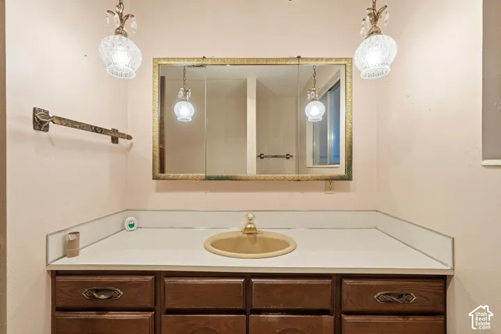Wood-finish vanity with drawer storage and under-sink cabinetry