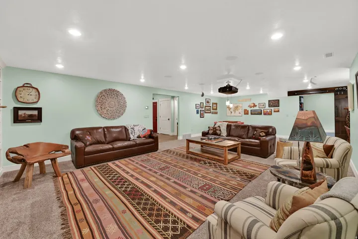 Carpeted recreation room with recessed lighting and a ceiling-mounted projector