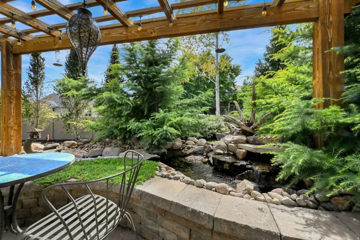 Pergola with exposed beams and attached string lighting