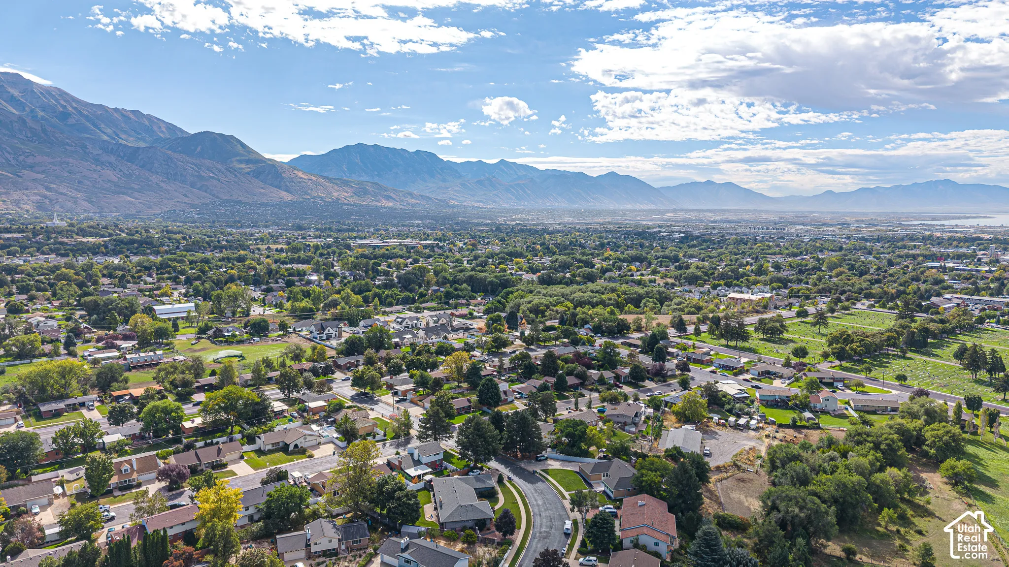 Expansive residential area with a verdant landscape and distant mountain ranges