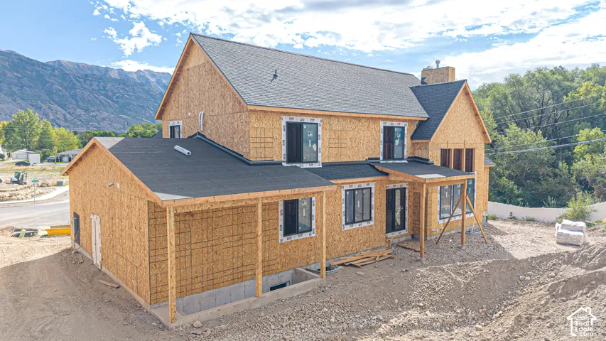 Newly constructed property featuring a full foundation, multiple gables, and a prominent chimney