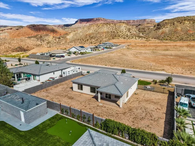 Single-story residence with a covered patio, tile roof, and desert landscaping