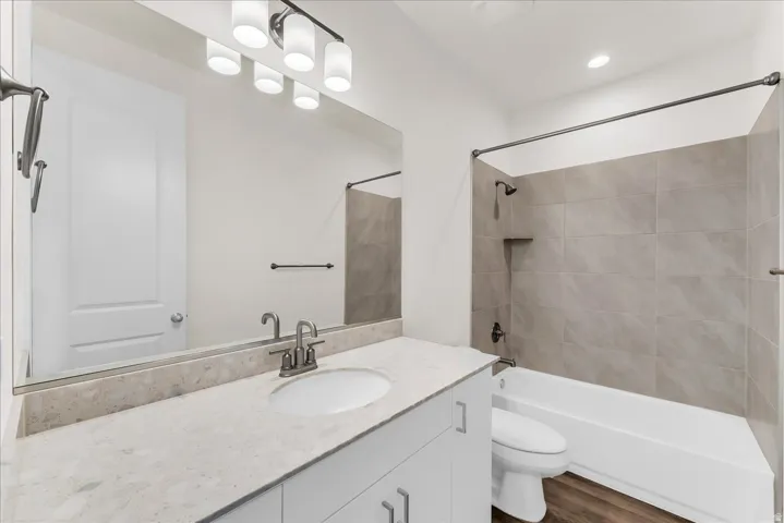 Vanity with light-toned countertop, oval undermount sink, and contemporary faucet