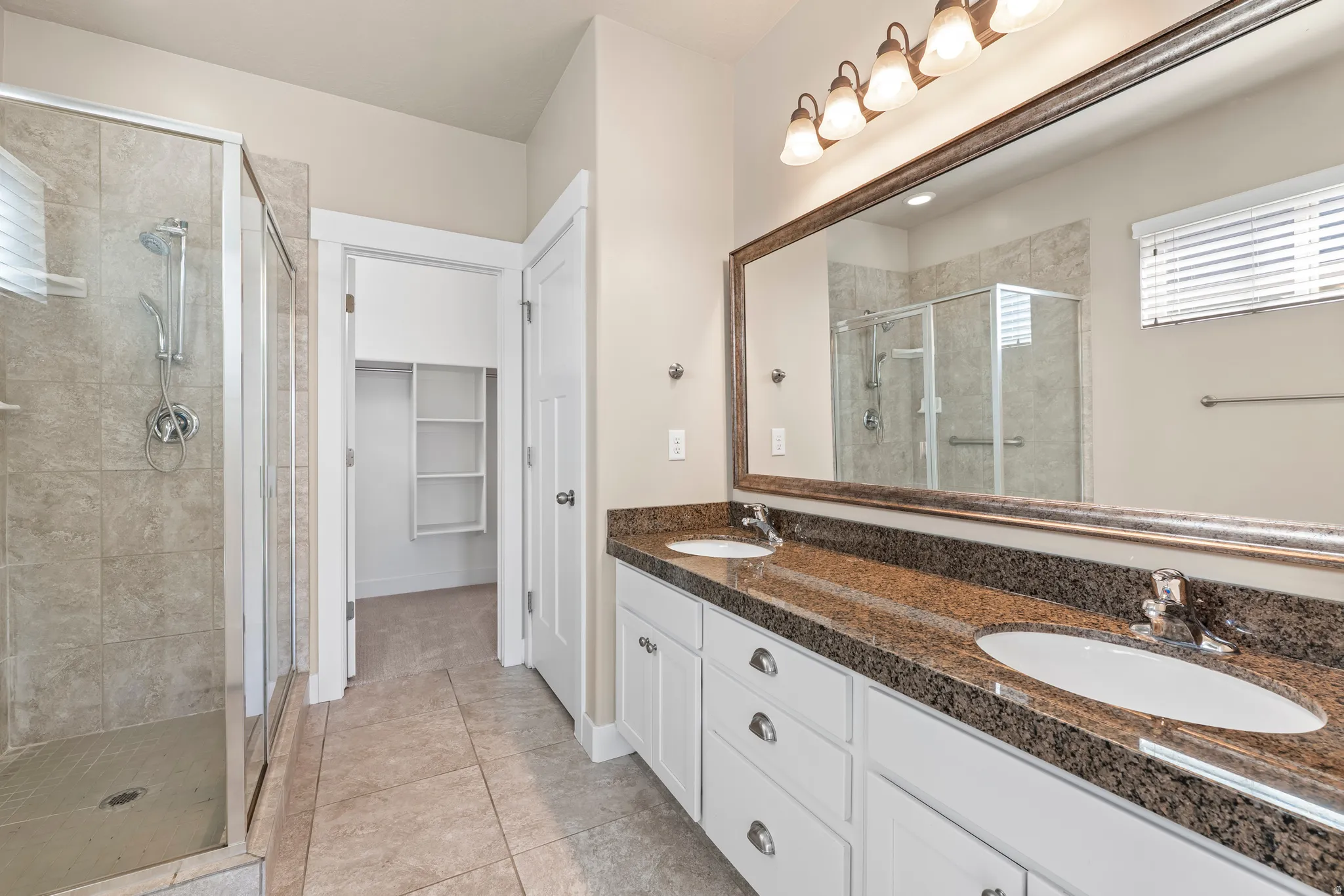 Double vanity with stone countertop and dual undermount sinks