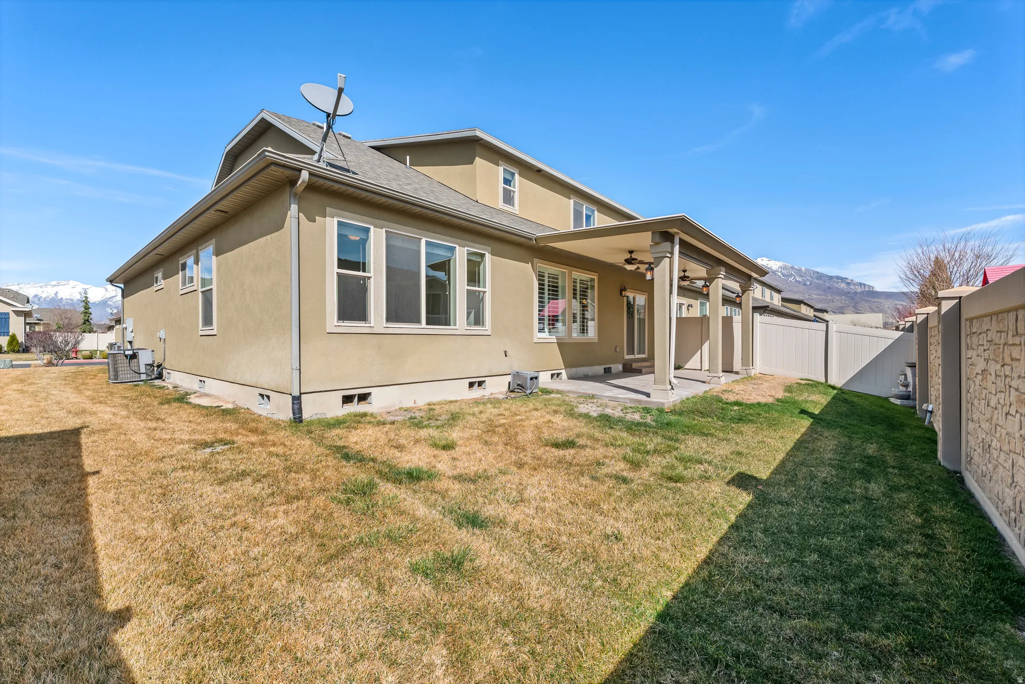 Rear exterior featuring stucco siding and multiple windows