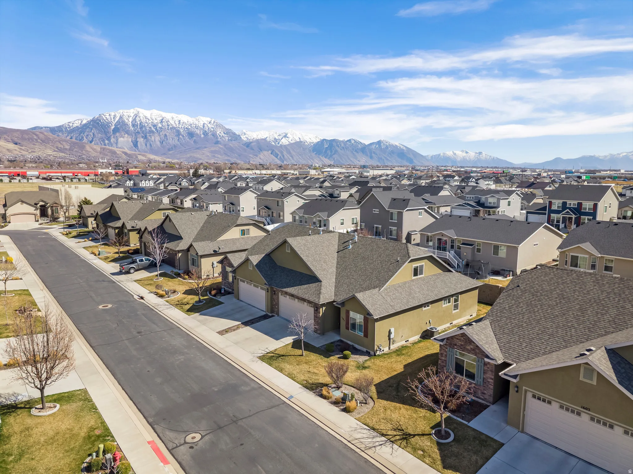 Residential neighborhood featuring single-family homes with pitched roofs and attached garages