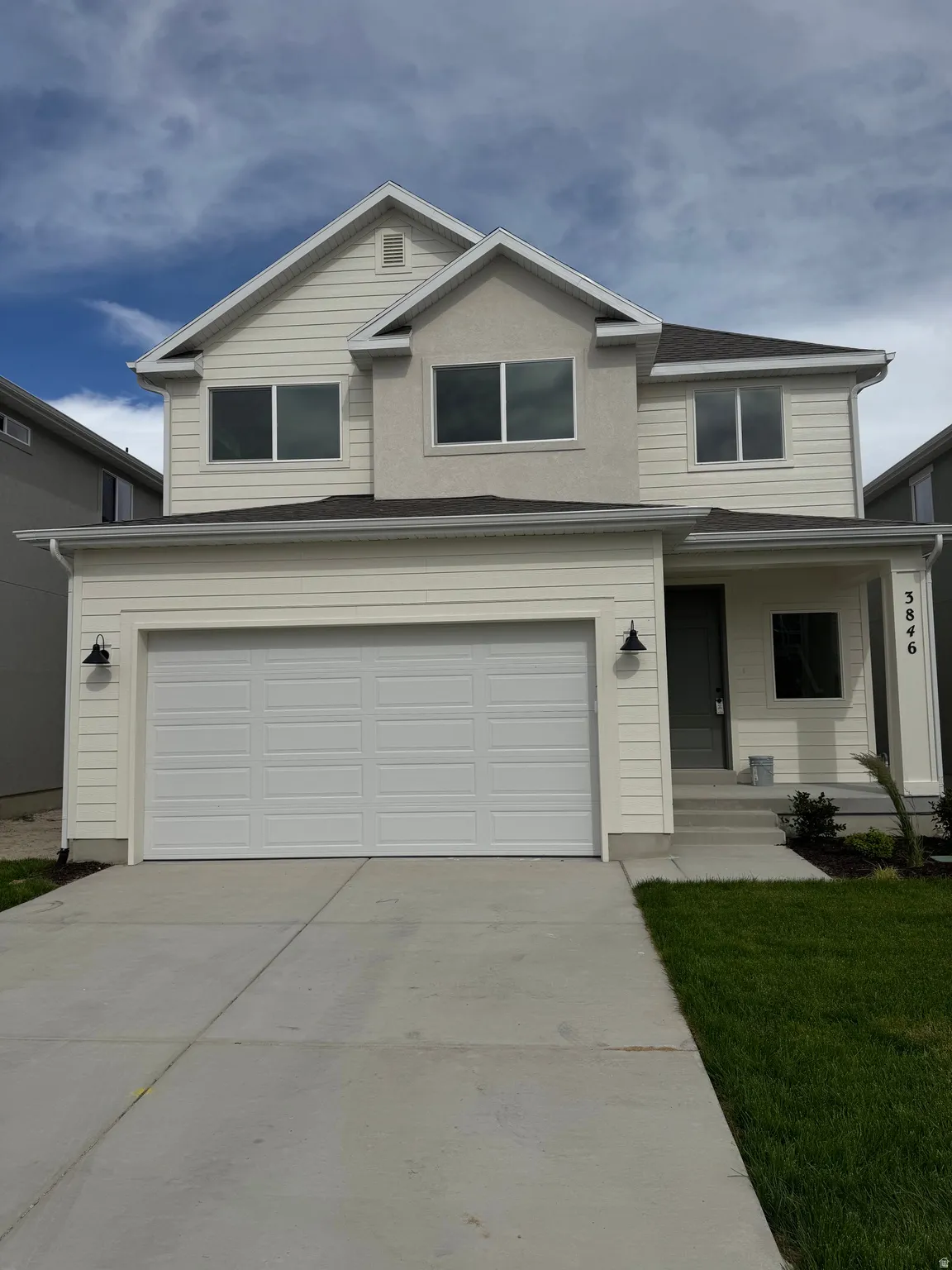 Two-story home featuring a combination of siding and stucco, a two-car garage, concrete driveway, and a front entry with steps