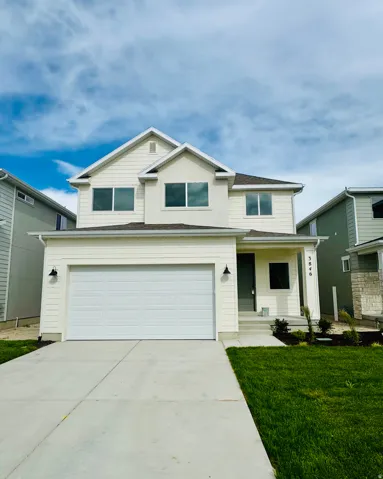 Two-story exterior with a two-car garage, concrete driveway, and covered front entry