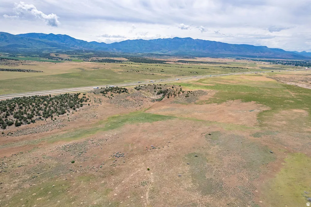 Expansive undeveloped land featuring a highway and distant mountain range