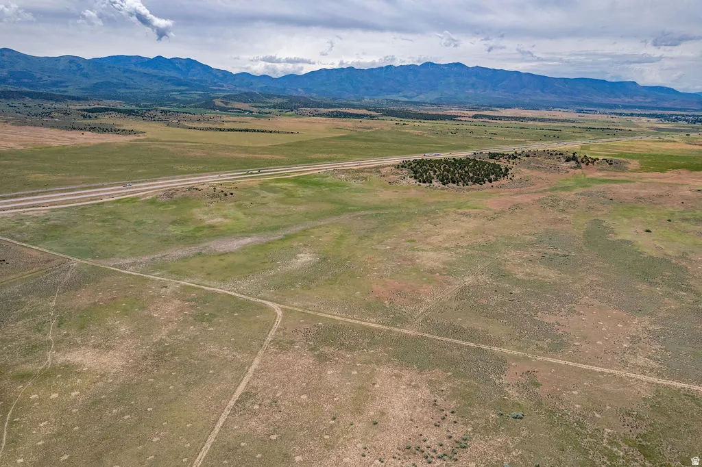 Expansive undeveloped land featuring natural terrain and distant mountains
