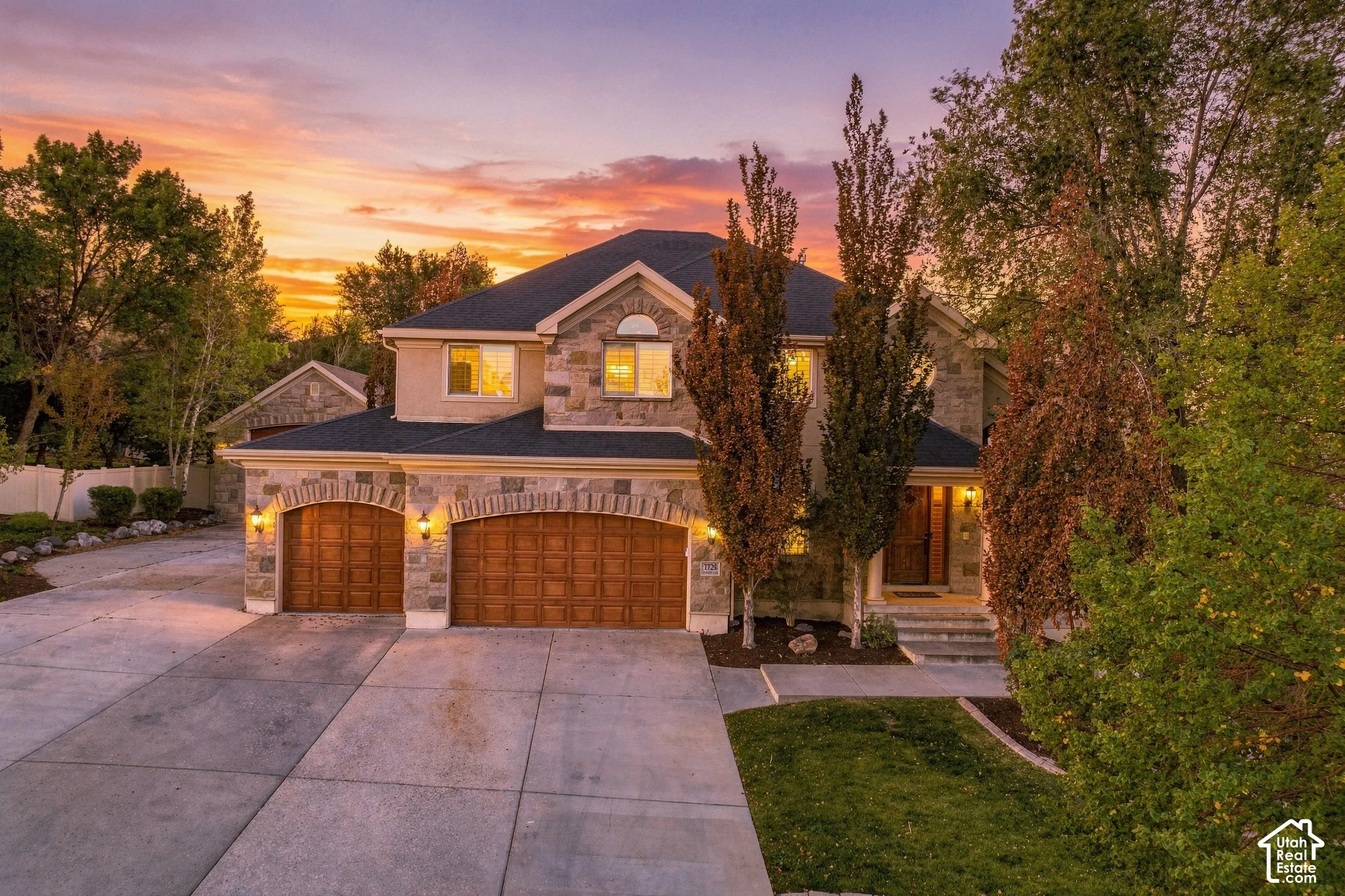 Stone and stucco exterior with a dark-pitched roof