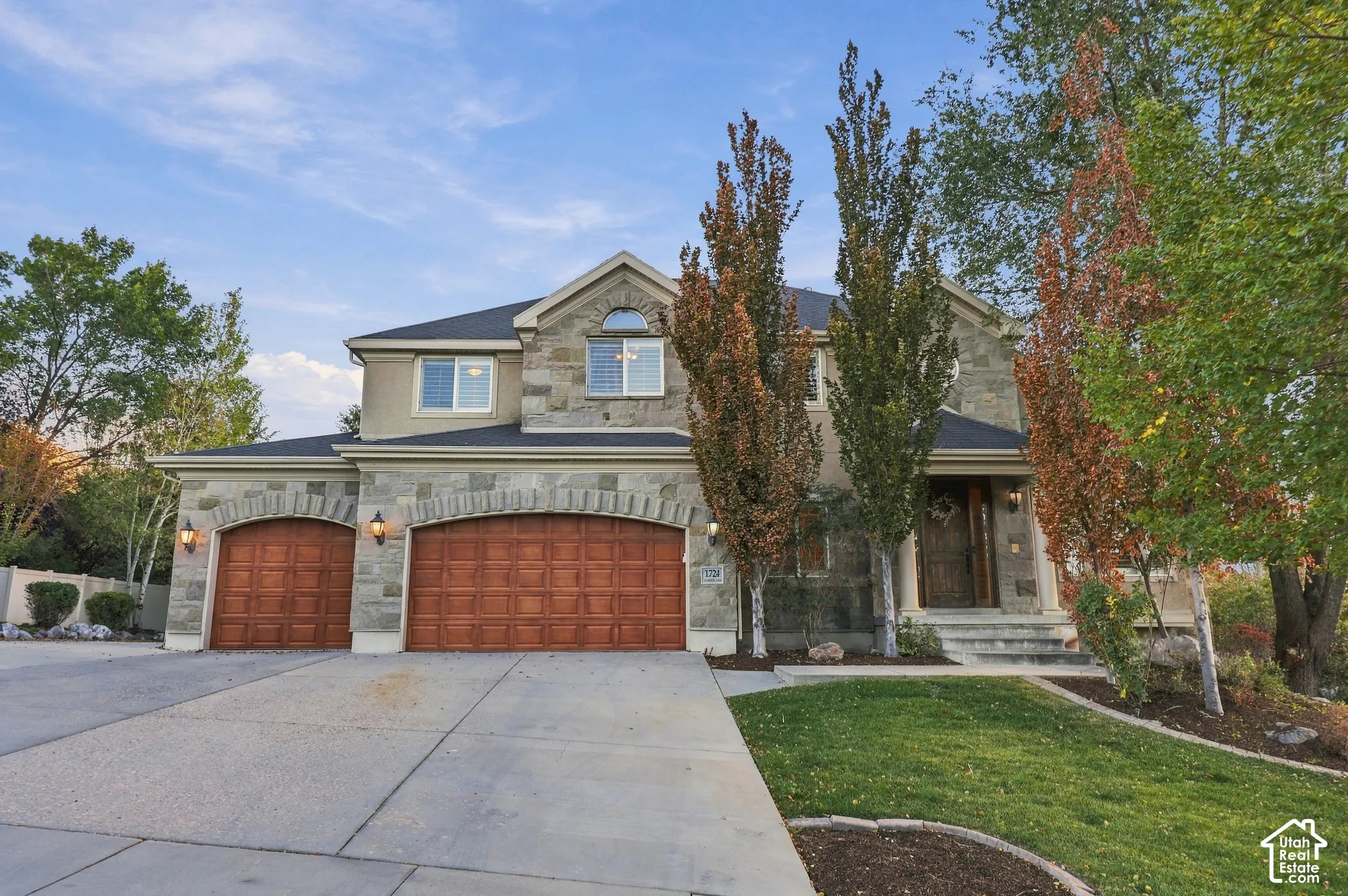 Stone and stucco exterior with an arched entry