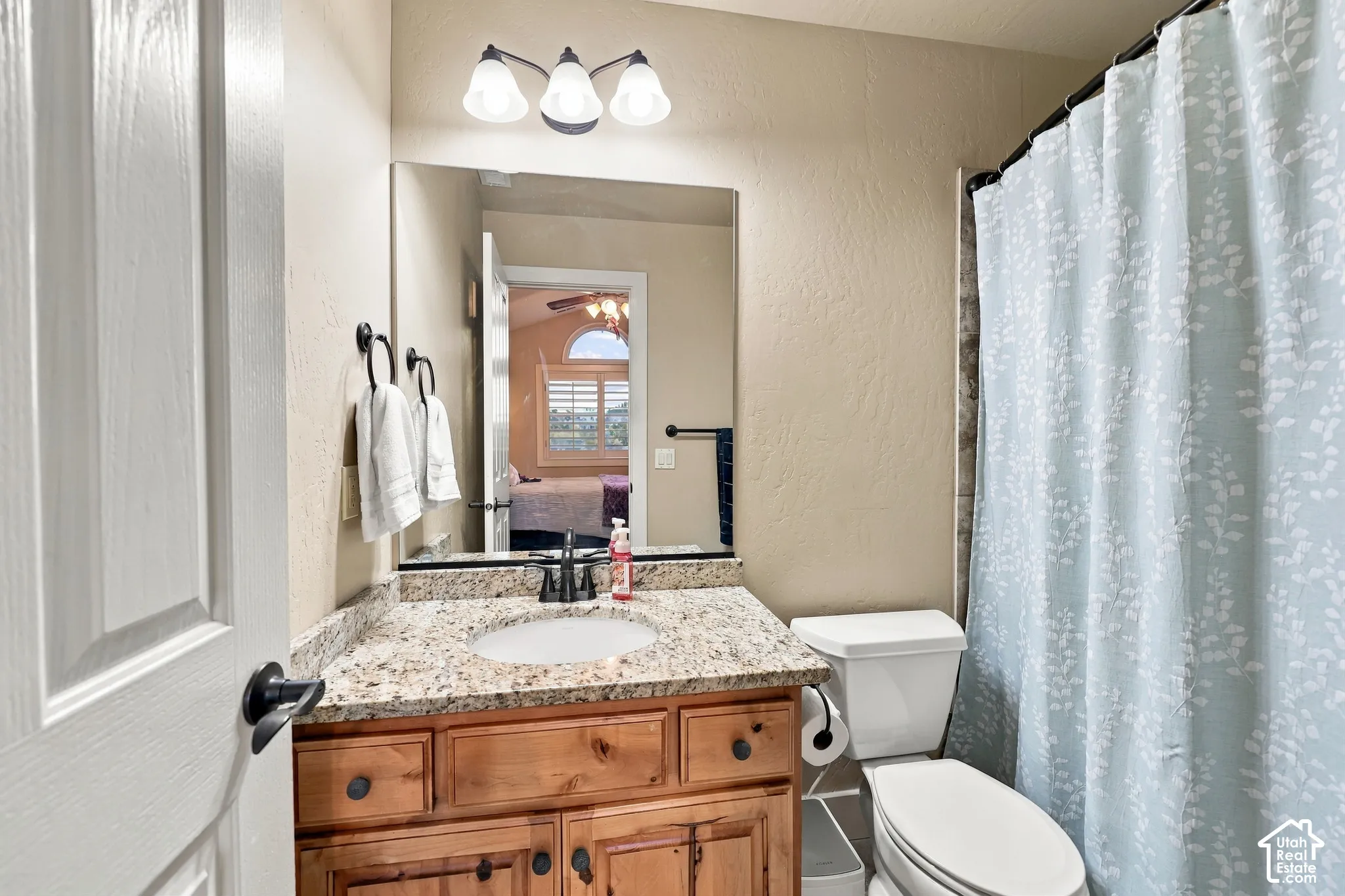 Vanity with a granite countertop and an undermount sink