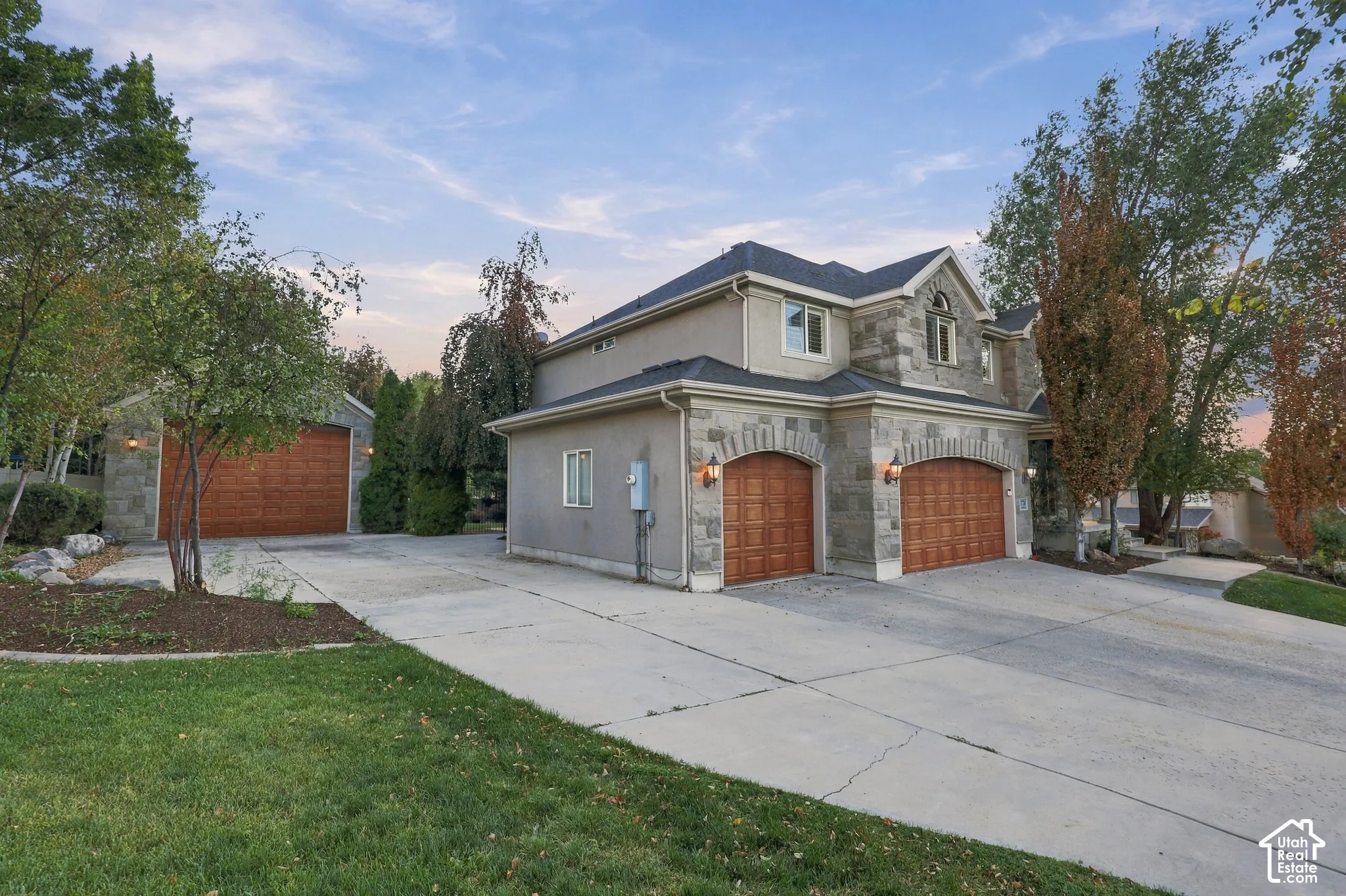 Stone veneer and stucco exterior with multiple gables