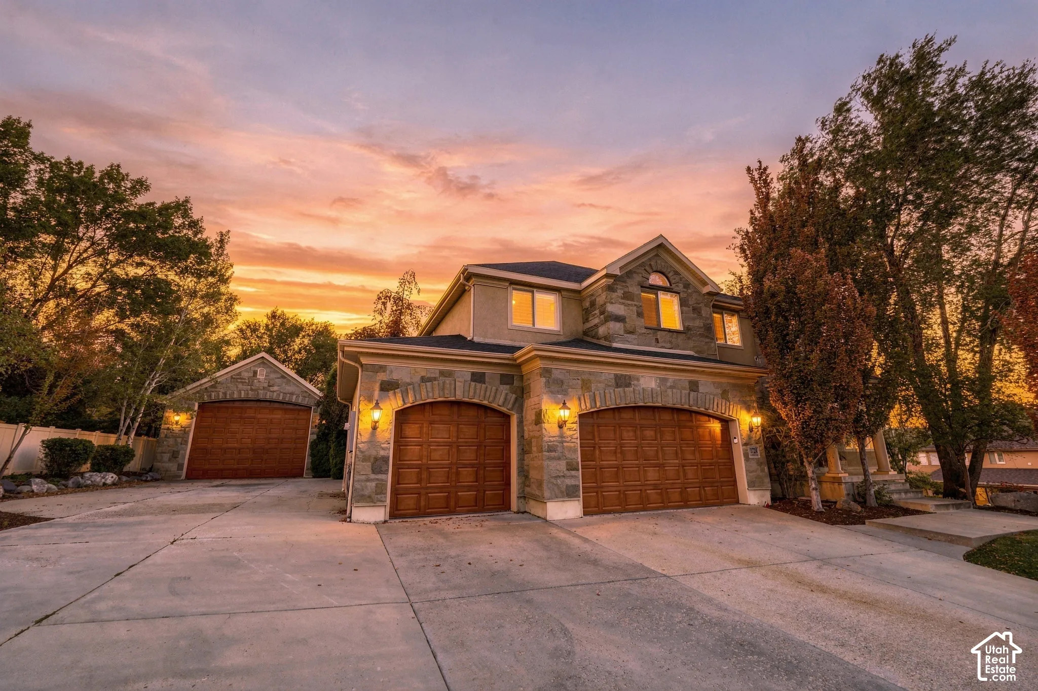 Stone facade with arched wood-finish garage doors