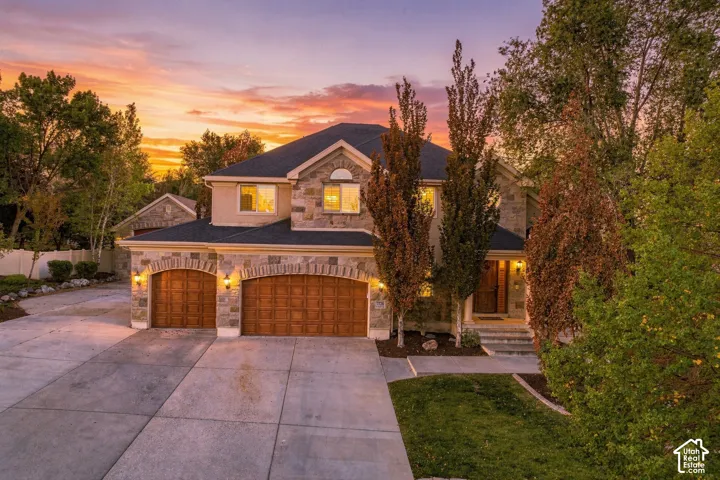 Stone and stucco exterior with a dark-pitched roof