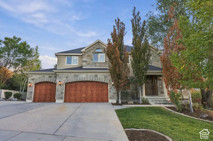 Stone and stucco exterior with an arched entry