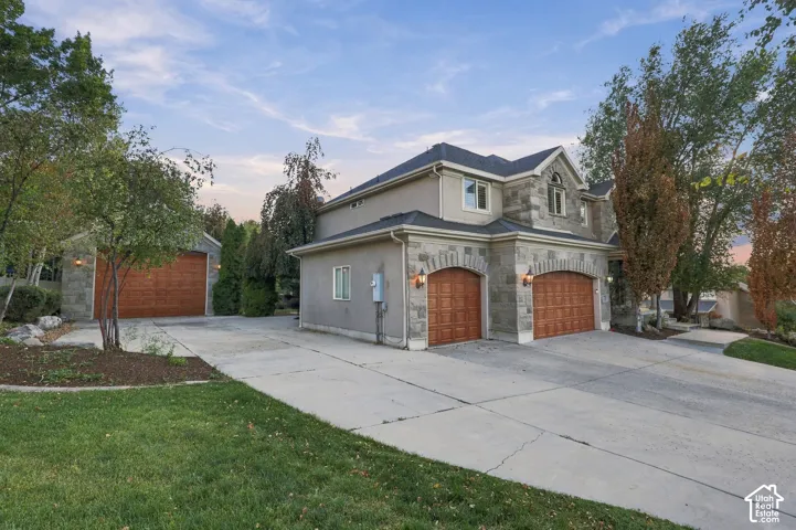 Stone veneer and stucco exterior with multiple gables