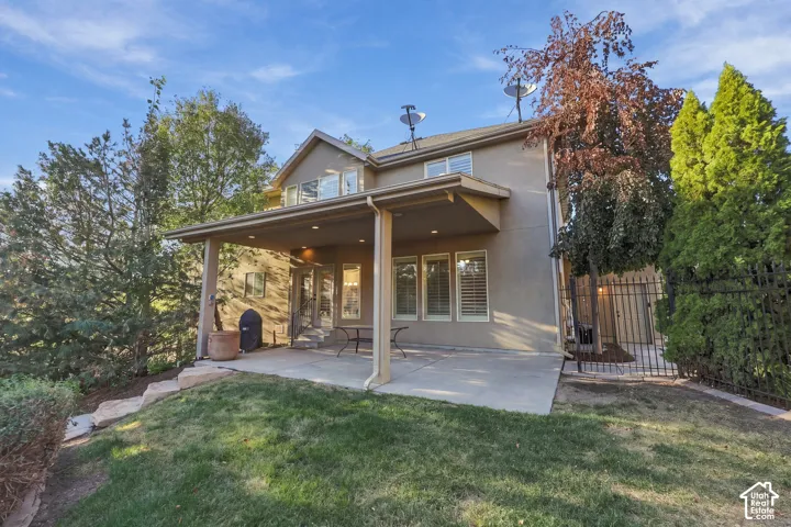 Expansive concrete patio with a covered outdoor living area and recessed lighting