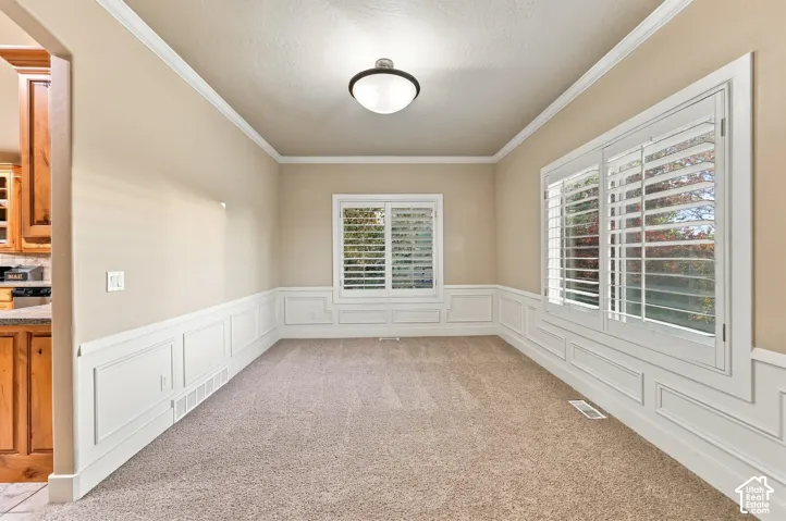 Crown molding and wainscoting details accent the walls