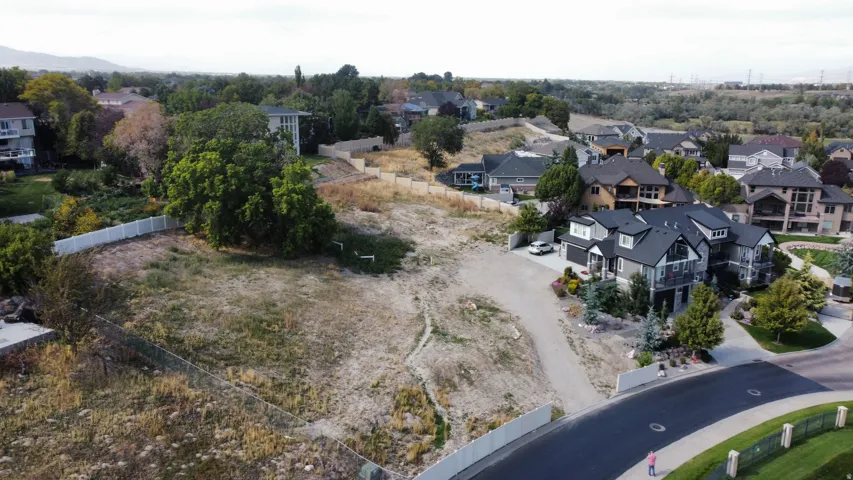 Expansive lot with mature trees and perimeter fencing