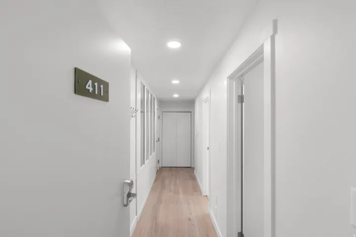 Hallway featuring wood-finish flooring and recessed ceiling lighting