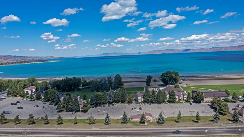 Expansive lakefront property featuring multiple buildings, extensive parking areas, and mature landscaping