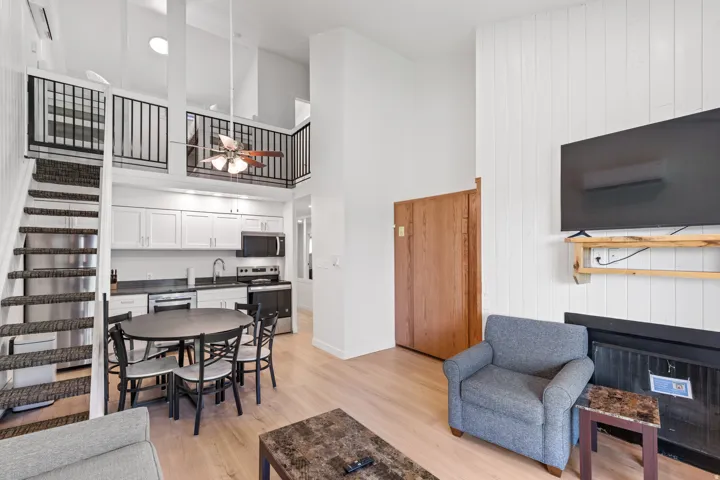 Open-concept living area featuring a kitchen, dining space, and loft