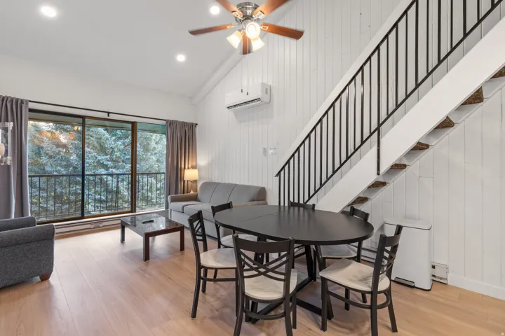 Vaulted ceiling with recessed lighting and a ceiling fan