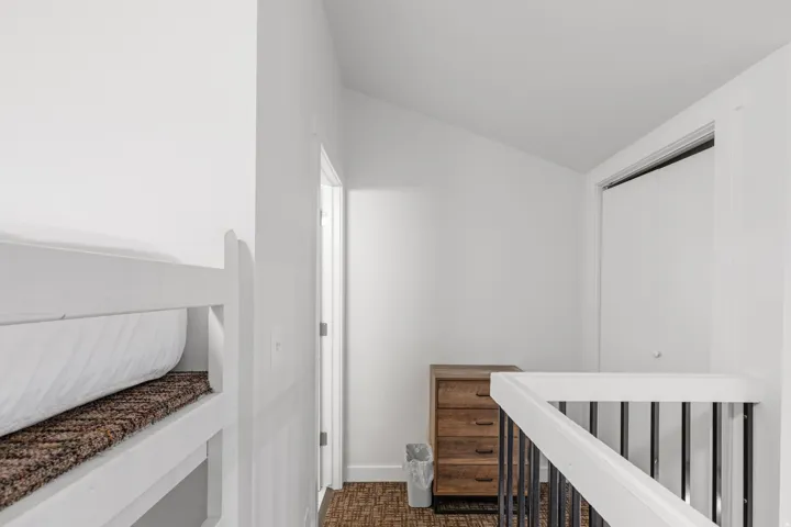 White interior walls with a sloped ceiling